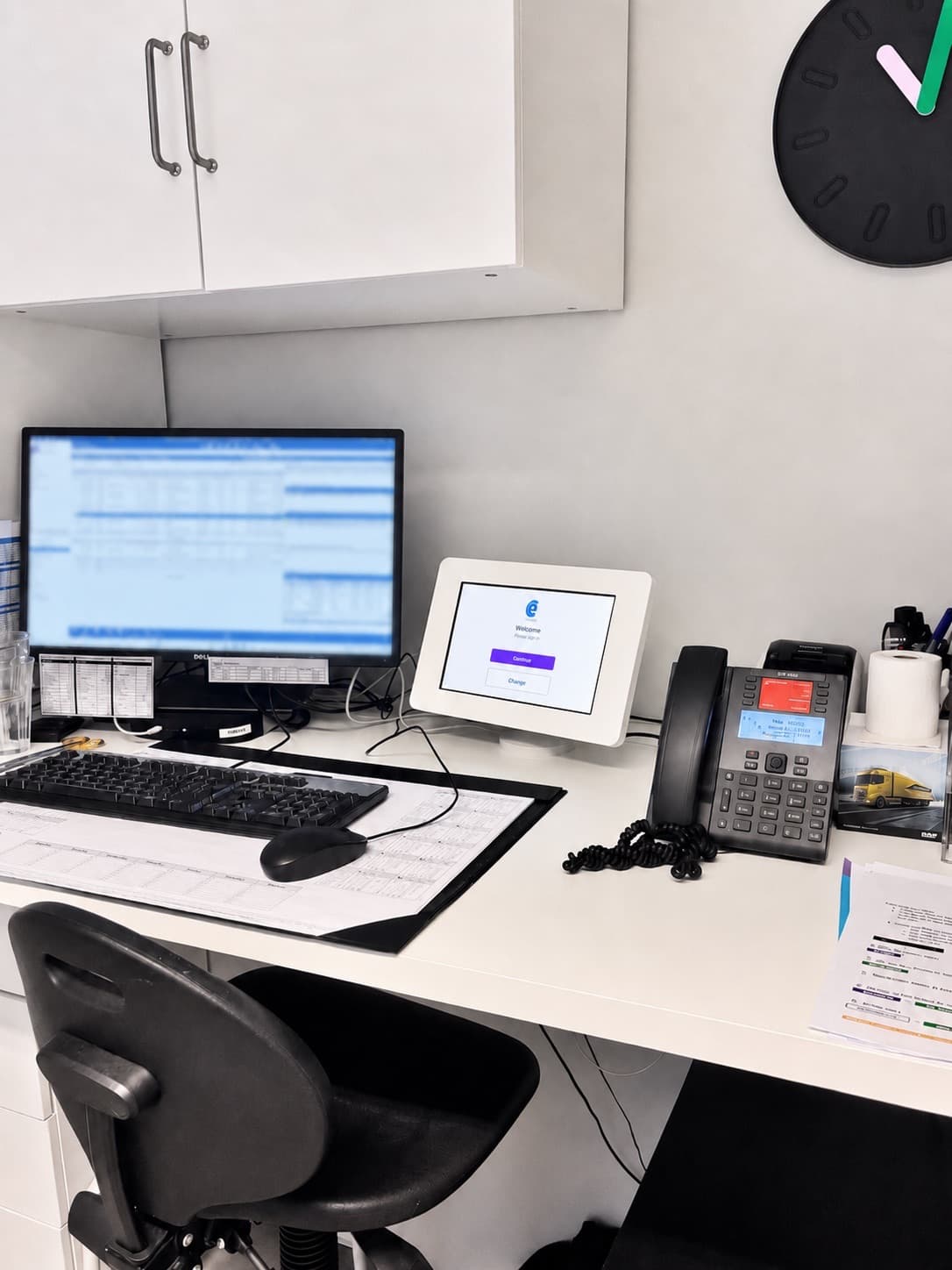 The Embracing Care tablet app on the plaster-room desk, beside the patient record screen